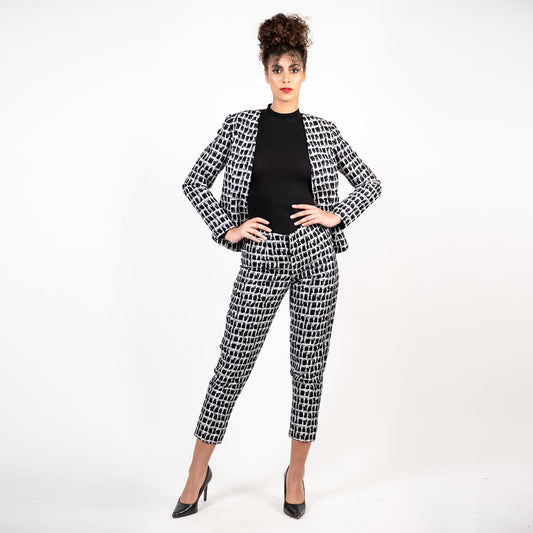 Woman wearing a black and white patterned suit on a white background