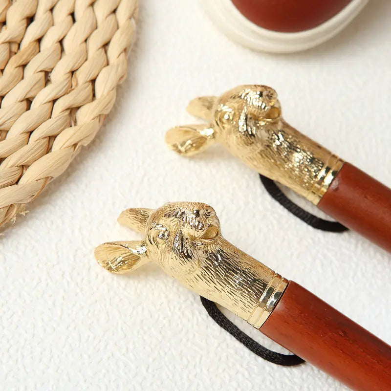 Two walking sticks with gold lion head handles on a textured surface.