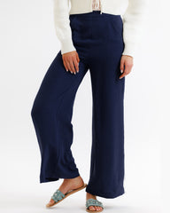 Navy wide-leg pants worn by a person on a white background