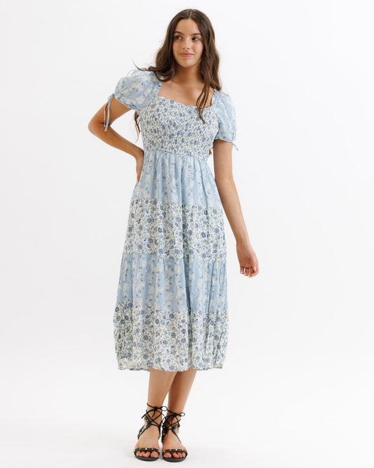 Woman wearing a floral dress on a white background