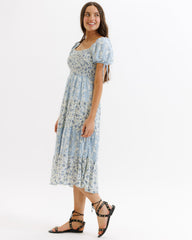 Woman wearing a floral dress on a white background