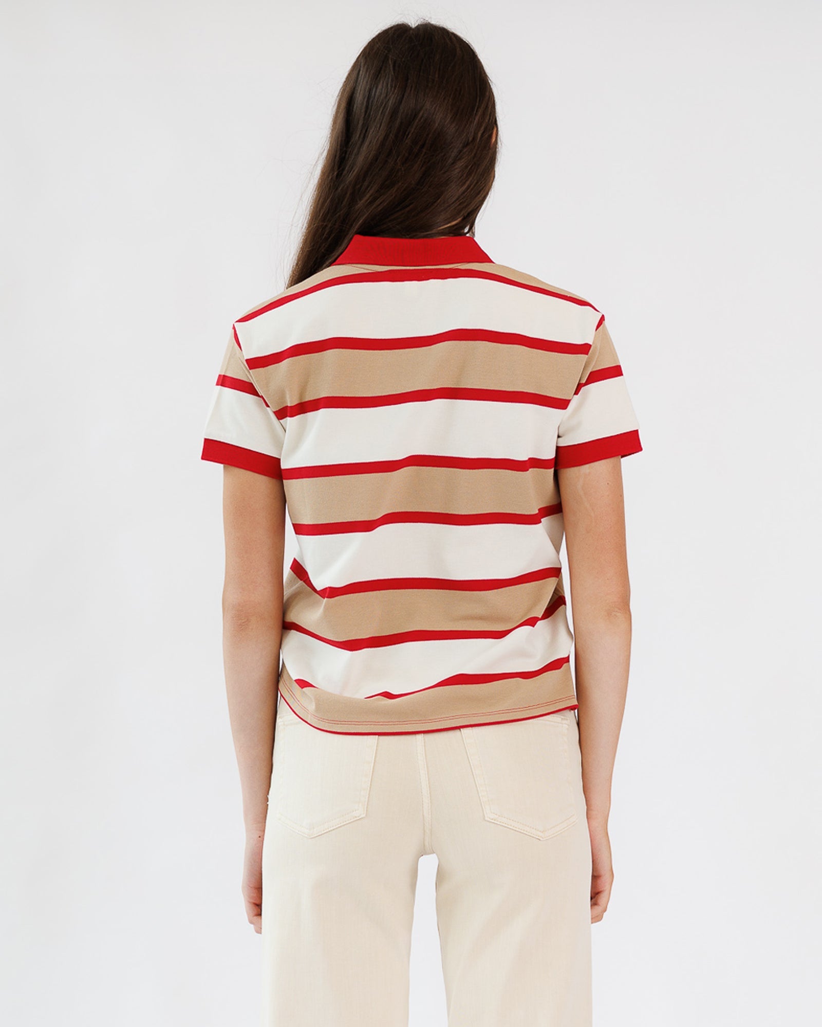 Person wearing a red and beige striped shirt on a white background