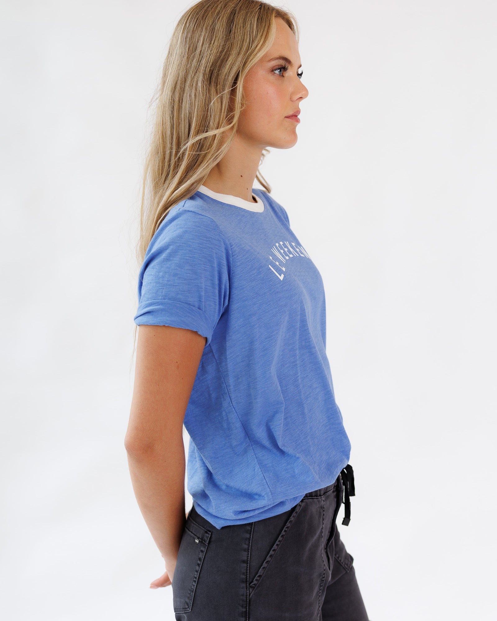 Woman wearing a blue t-shirt with text on a white background