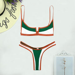 Green and orange bikini set on a white background with decorative elements.