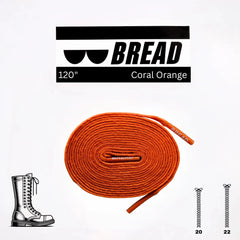 Orange shoelaces with 'BREAD' branding on a white background