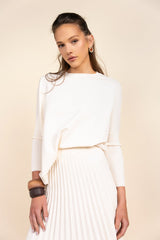 Woman wearing a white dress with a beige background