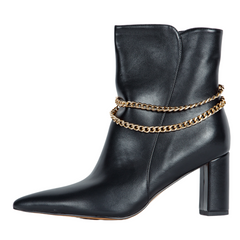 Black leather ankle boot with gold chain detail on a white background