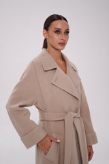 Woman wearing a beige trench coat against a white background