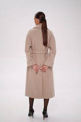 Woman wearing a beige trench coat on a white background