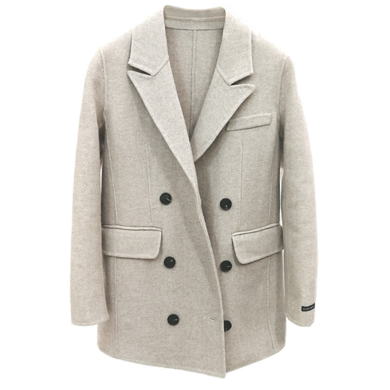 Beige double-breasted coat with black buttons on a white background