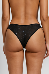 Black star-patterned underwear worn by a person on a neutral background