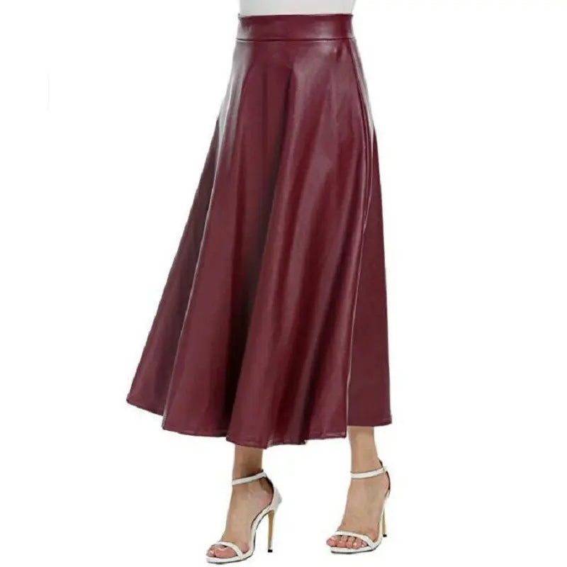 A person wearing a high-waisted brown PU leather long skirt with a flared design, paired with heels.