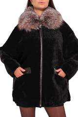Woman wearing a black coat with fur collar on a white background