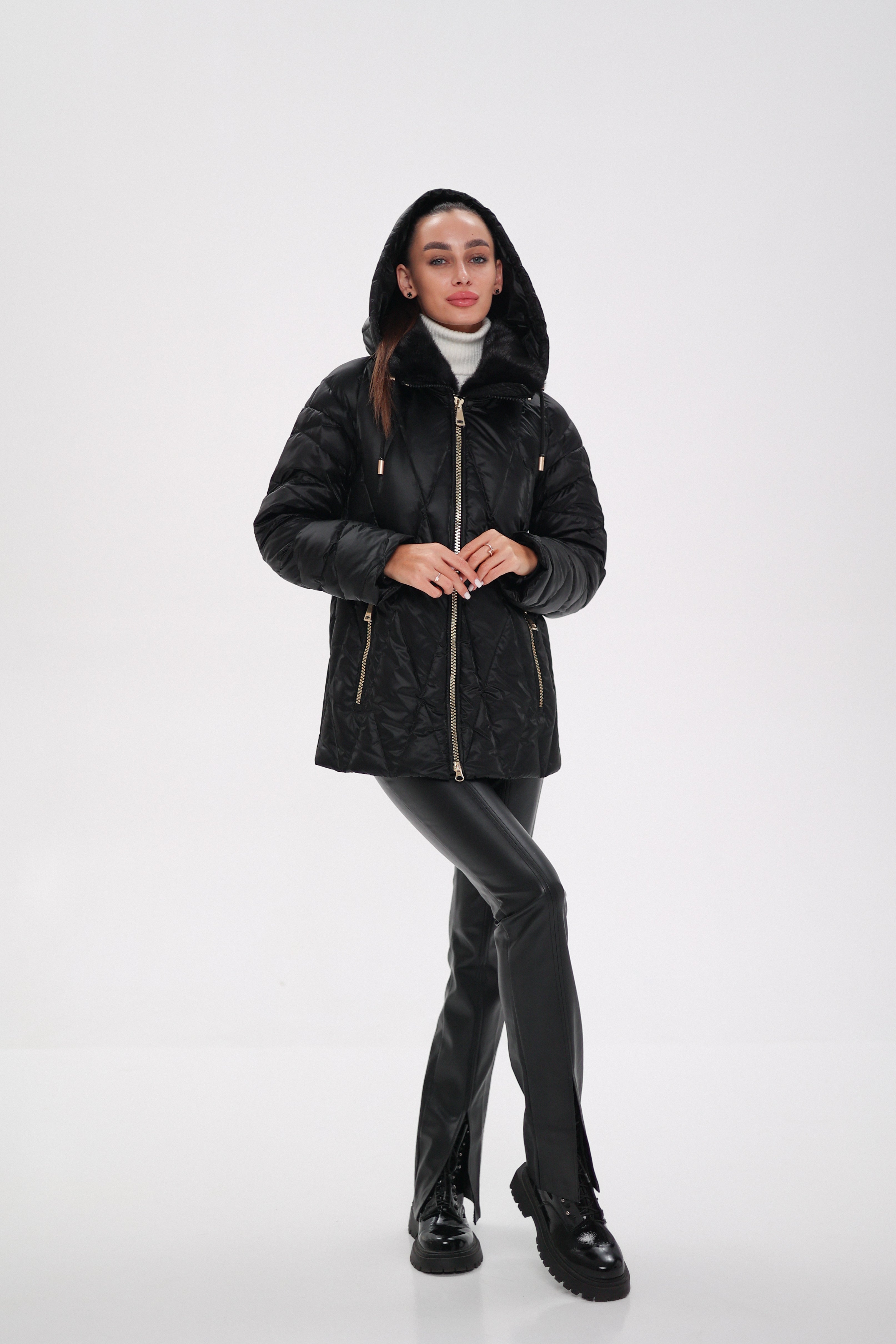 Person wearing a black hooded jacket on a white background