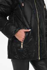 Close-up of a black coat with a silver buckle on a white background