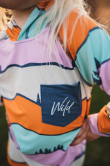 Colorful jacket with 'Wild' text on a blurred background