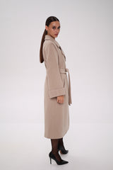 Woman wearing a beige trench coat on a white background