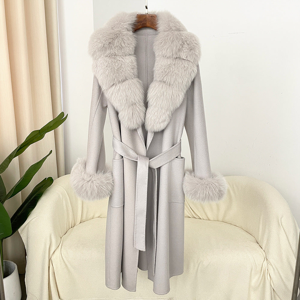 Gray coat with fur collar and cuffs on a mannequin against a white background