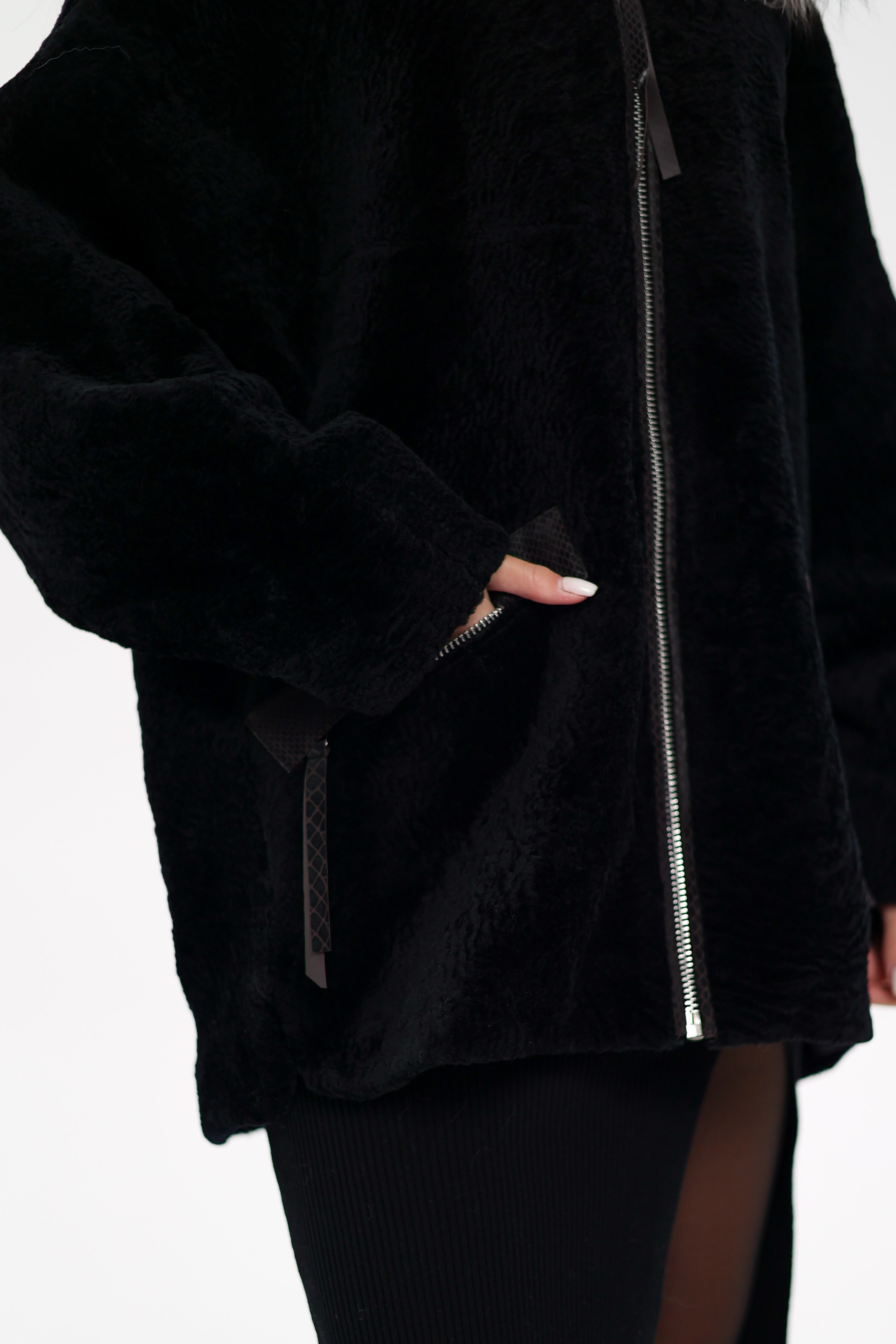 Black fleece jacket with a zipper on a white background
