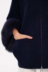 Navy blue coat with fur-trimmed sleeves on a white background