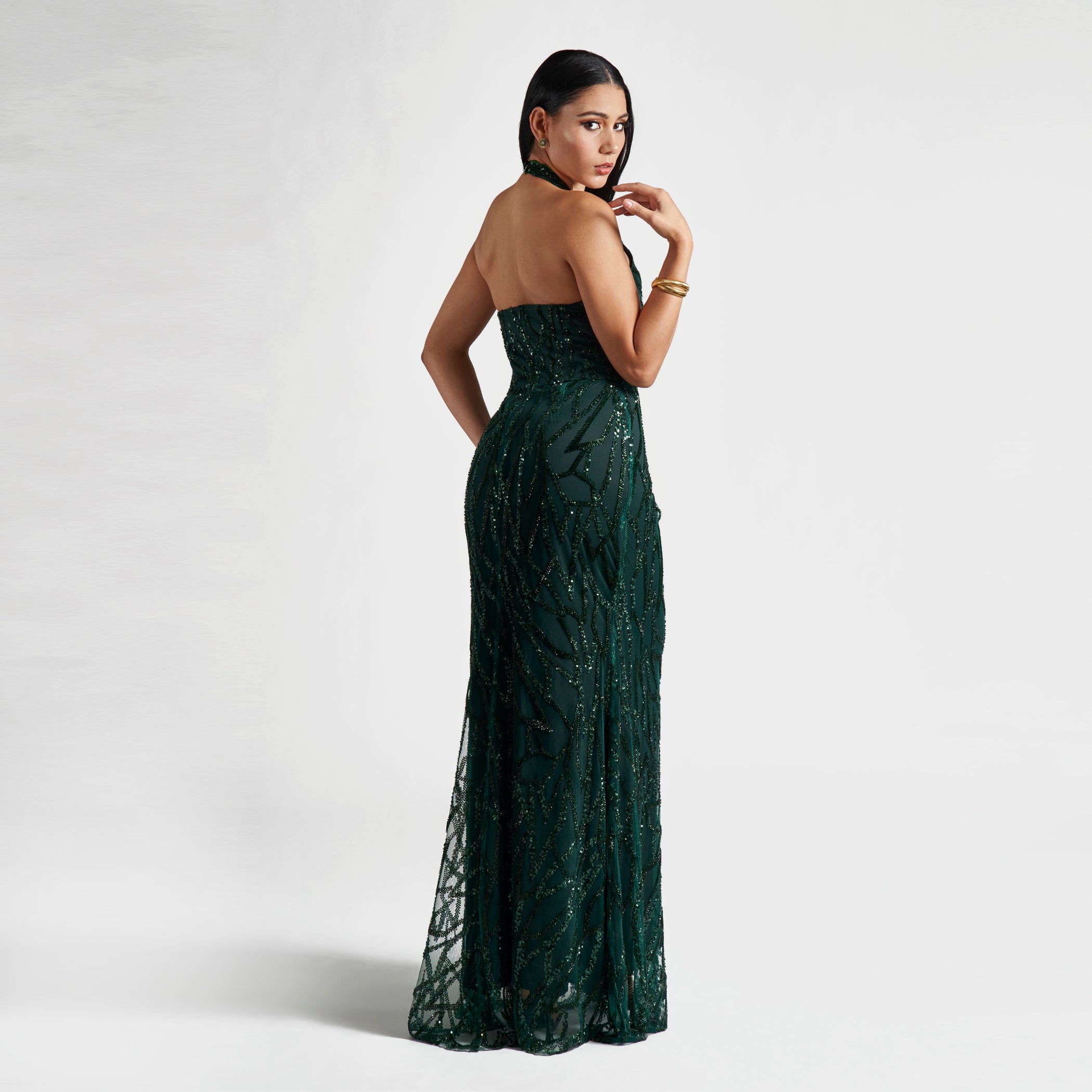 Woman wearing a green strapless dress against a white background