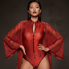 Model wearing a red patterned outfit with a dark background