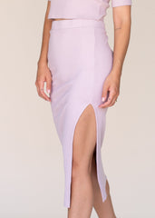 Lavender ribbed skirt with a front slit on a plain background