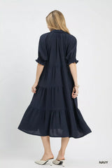 Woman wearing a navy dress on a white background