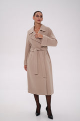 Woman wearing a beige trench coat on a white background