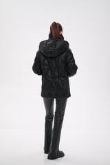 Person wearing a black puffer jacket and pants on a white background