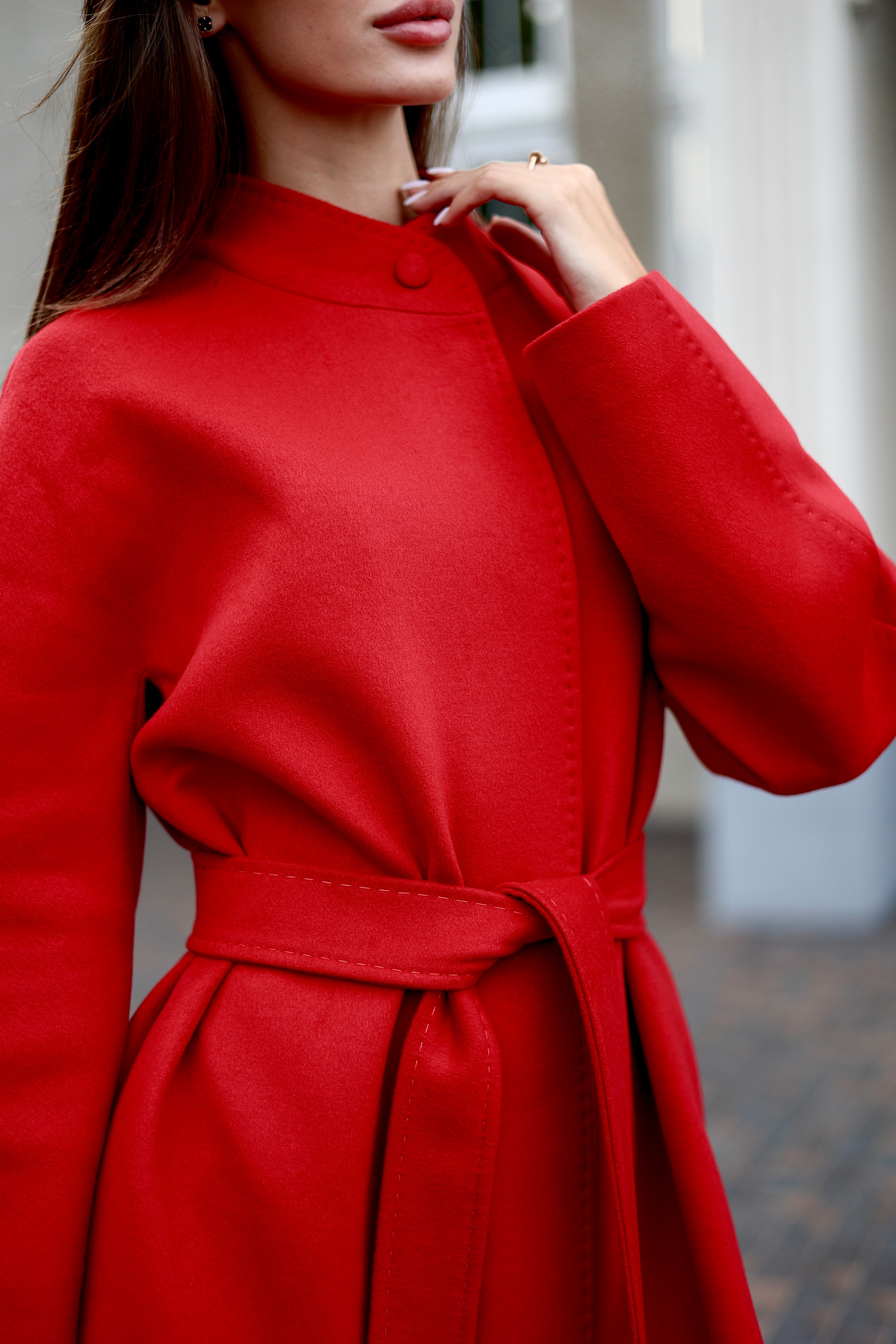 Red coat worn by a person with a blurred background