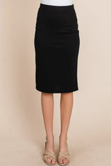 Black pencil skirt worn by a person on a beige background