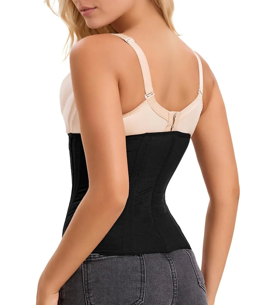 Woman wearing a black waist trainer with beige bra on a white background