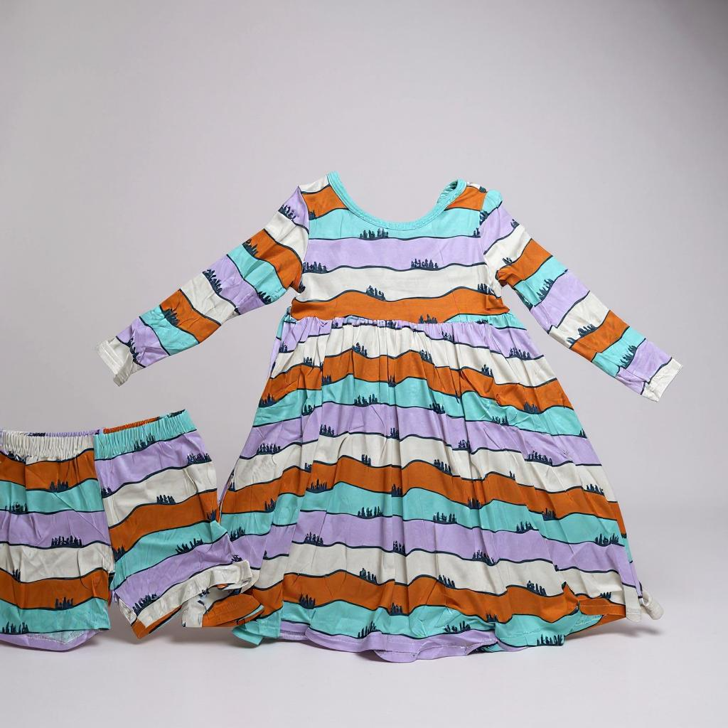 Colorful striped dress and bloomers set on a gray background