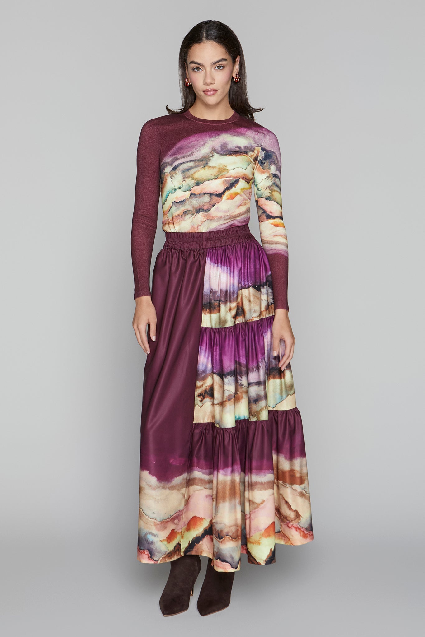 Woman wearing a long, multicolored dress with a blurred background