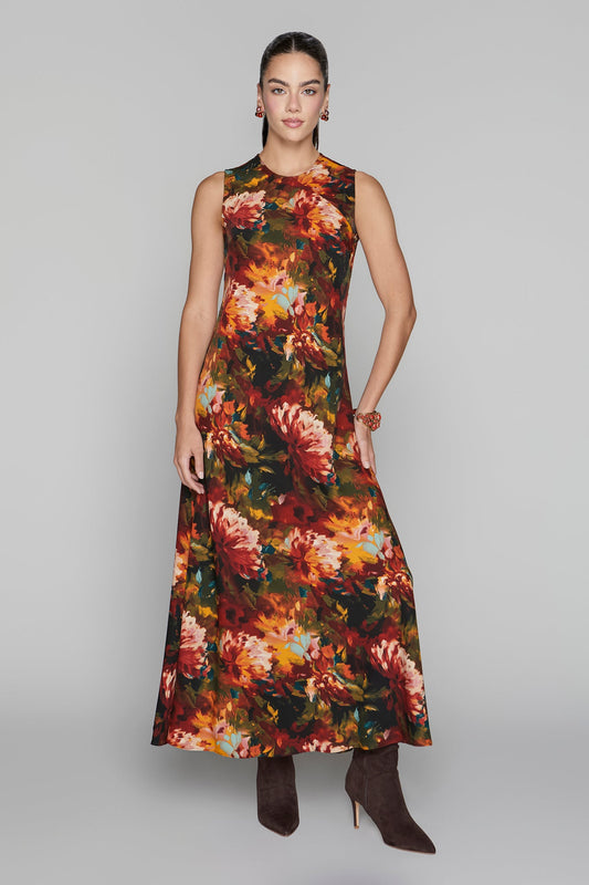 Woman wearing a sleeveless floral dress on a gray background