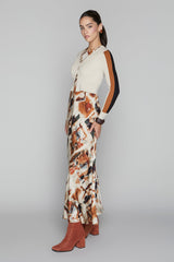 Woman wearing a patterned dress with a neutral background