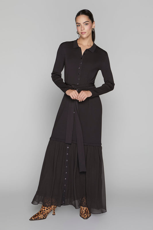 Woman wearing a black dress with a plain background