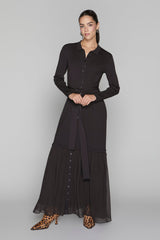 Woman wearing a black dress with a plain background