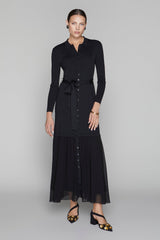 Woman wearing a black dress with a belt on a gray background