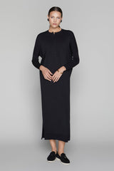 Woman wearing a black dress on a gray background