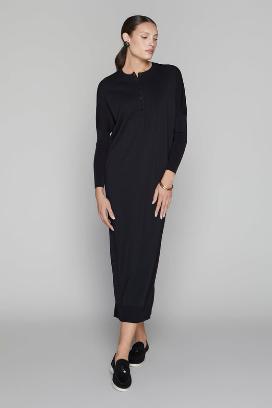 Woman wearing a black dress on a gray background