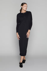 Woman wearing a black dress on a gray background