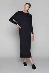 Woman wearing a black dress on a gray background