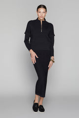 Woman wearing a black outfit on a gray background