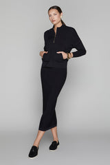 Woman wearing a black outfit on a gray background