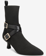Black ankle boot with gold buckles on a white background