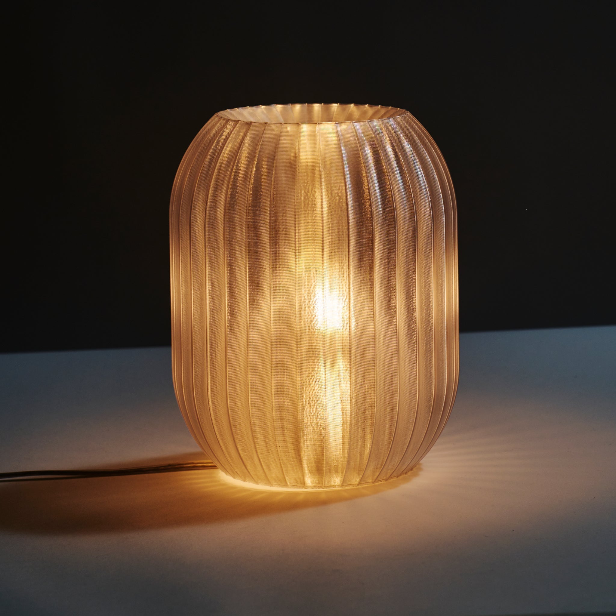 Decorative lamp with ribbed design on a dark background