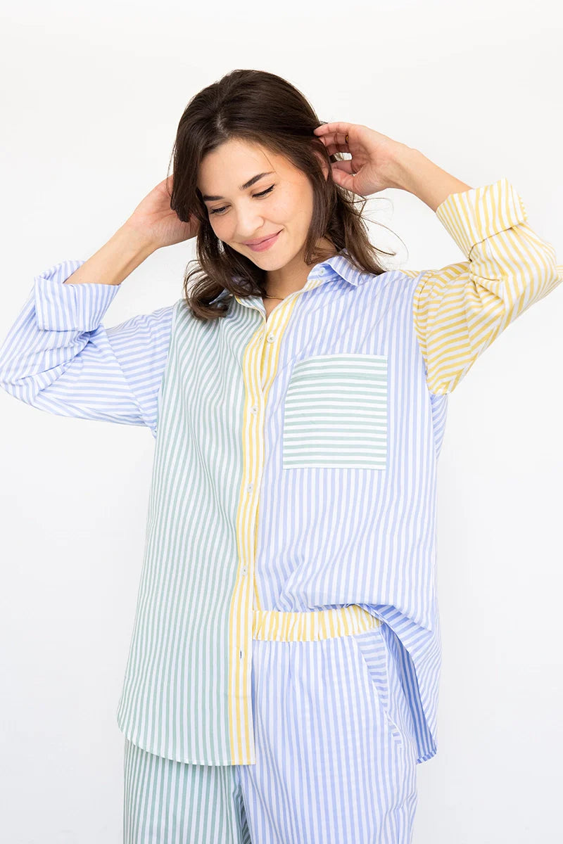 Woman wearing a light blue and yellow striped outfit on a white background