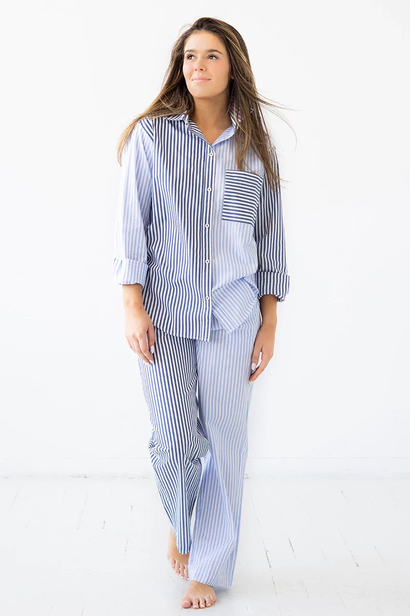 Woman wearing a blue and white striped pajama set on a white background